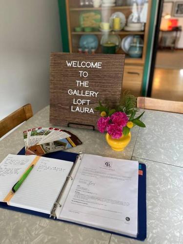 a welcome to the california lottery sign and flowers on a table at Gallery Loft of Oak Park #1 Top Host in IL in Oak Park