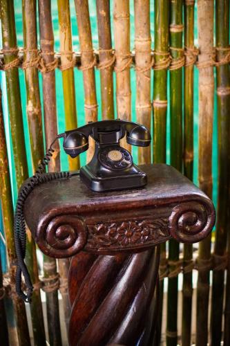 a telephone sitting on top of a wooden table at New Common Home in Agonda