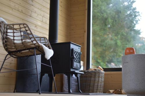 a chair sitting next to a television on a table at Tinyhouse Březina in Dolní Bezděkov