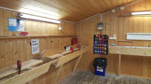 a room with wooden walls and benches in a store at Nordseter Hytter in Nordseter