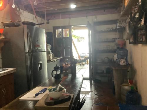 a kitchen with a refrigerator and a table in it at Life is Good in Bocas del Toro