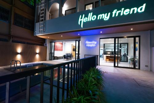 a hotel entrance with a sign that reads hello my friend at Hello my friend in Bang Bua Thong Railway Station