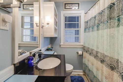 a bathroom with a sink and a toilet at The Cozy Blue Cottage in Long Beach