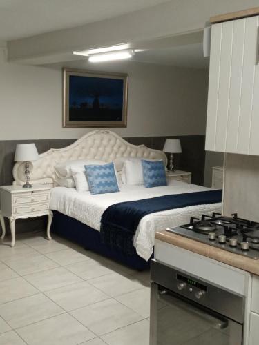 a bedroom with a bed with blue pillows and a stove at Knysna Nature's View in Knysna