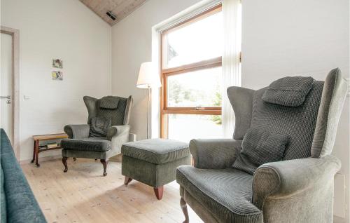 a living room with chairs and a chair and a window at Holiday Home Strandvænget Ix in Helberskov
