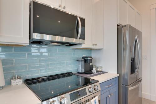 a kitchen with a stove and a microwave at Walk to Ocean Home with Deck in Surfside Beach! in Surfside Beach