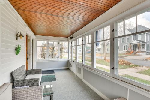 a screened porch with a couch and windows at Walk to Downtown - Home with Porch in Clayton! in Clayton