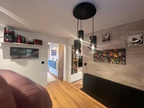 a living room with a couch and some pictures on the wall at Ferienwohnung E in Soltau