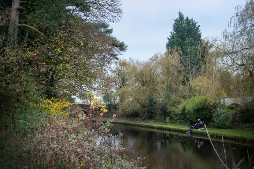 a person is pulling a rope in a river at Architect-Designed Rural Cabin - Year Round Retreat in Market Drayton