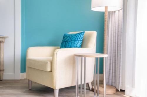 a living room with a chair and a lamp at Margaritaville Resort Cape Cod in Hyannis