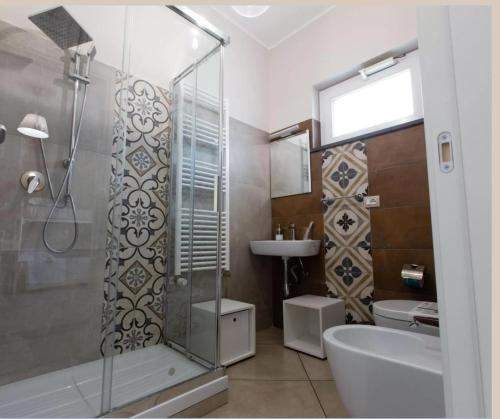 a bathroom with a shower and a toilet and a sink at Crialesi Boutique Rooms in Falerna