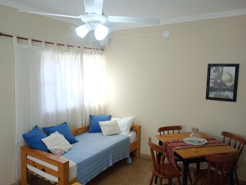 a bedroom with a bed and a table with a dining room at Temporario Del Centro in Paso de los Libres