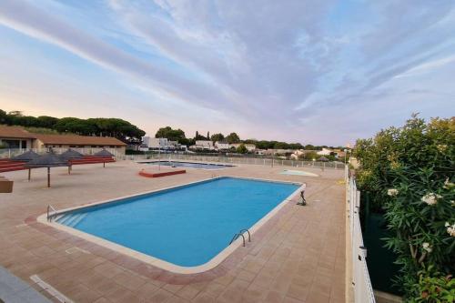 - une grande piscine sur une terrasse avec ciel ouvert dans l'établissement Maison dans résidence, piscines, proximité plage, à Vendres