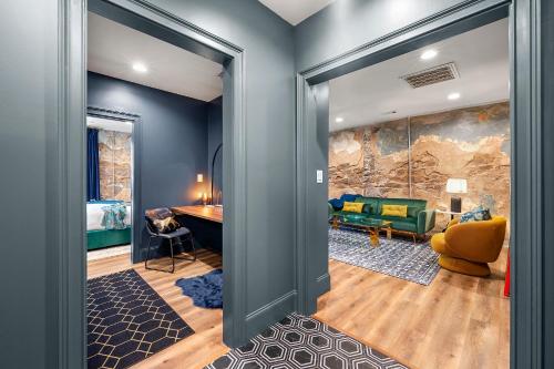 a living room with a couch and a table at Opulent Loft on Main St -Walk to Stone Mtn Park! in Stone Mountain