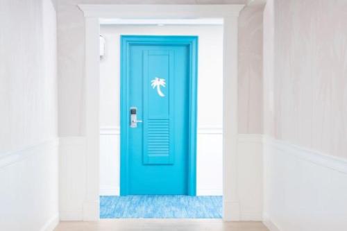 a blue door in the middle of a room at Margaritaville Resort Cape Cod in Hyannis