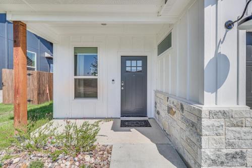 a white house with a black door at Newly Built Home Close to Parks and Dining! in Temple