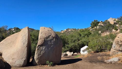 a group of large rocks on a dirt road at Splitrock - The Portal in Fallbrook