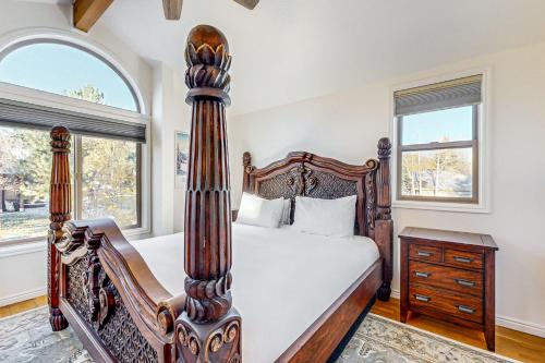 a bedroom with a large bed and a dresser and two windows at Mountain View Retreat - Unit A - Main Home in Park City