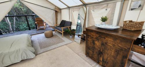 a room with a tent with a bed and a table at Splitrock - The Portal in Fallbrook
