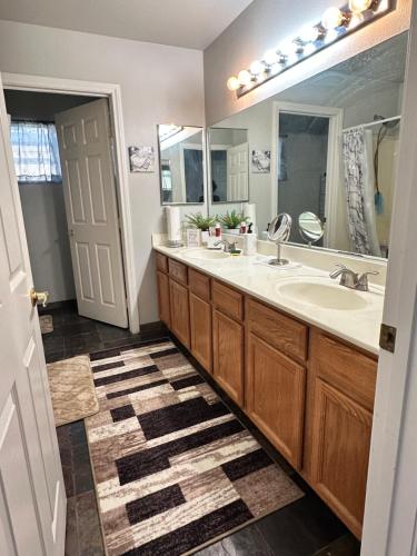 a bathroom with two sinks and a large mirror at LAS VEGAS SPACIOUS ROOM Close to Everything in Las Vegas