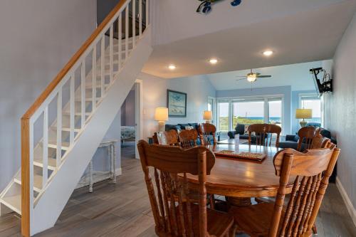 a dining room and living room with a table and chairs at Executive Keys Condominiums on the Beach in Port Aransas