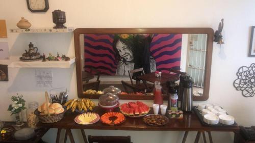 a mirror on a table with food on it at Aldeia Hostel in Manaus