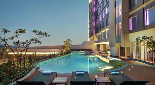a swimming pool in the middle of a building at Mercure Karawang in Karawang