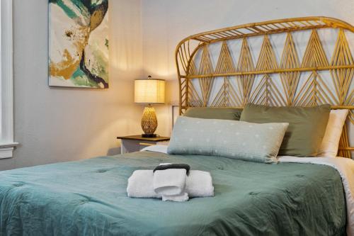 a bedroom with a bed with towels on it at Home Near Downtown Mall & Belmont in Charlottesville