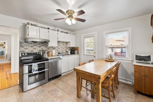 a kitchen with a table and a ceiling fan at Home Near Downtown Mall & Belmont in Charlottesville