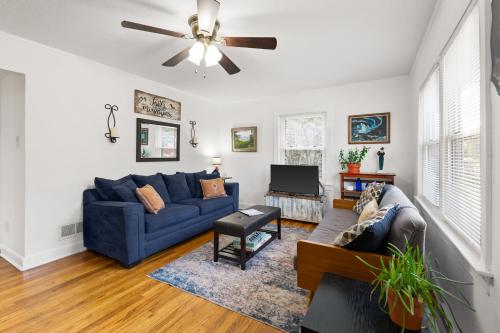 a living room with a blue couch and a ceiling fan at Home Near Downtown Mall & Belmont in Charlottesville