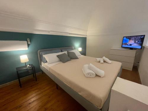 a bedroom with a bed with two towels on it at casa catania termini home 3 in Catania