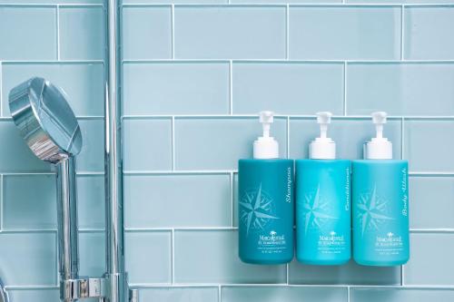 three bottles ofodorizers on a bathroom tile wall at Margaritaville Resort Cape Cod in Hyannis
