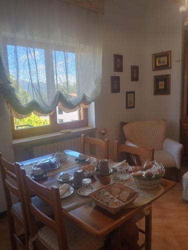 a table with food on it in a living room at B&B A Casa di Anna in Fassinoro