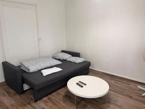 une petite pièce avec un lit et une table dans l'établissement Studio 30m2 à deux pas du centre-ville de Mulhouse, à Mulhouse