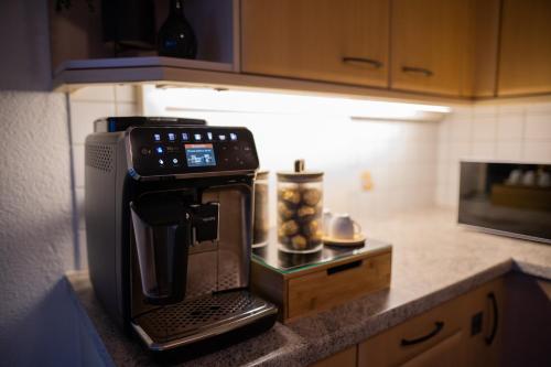 a coffee maker on a counter in a kitchen at Sky Paradise 20min to zurich city centre in Widen
