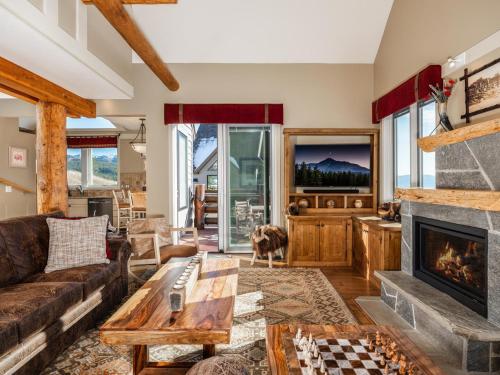 a living room with a couch and a fireplace at Saddle Ridge F5 home in Big Sky
