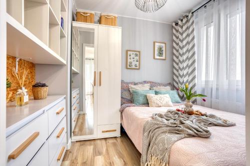 a small bedroom with a bed and a staircase at Dwupokojowy apartament Fordon w okolicy Onkologii in Bydgoszcz