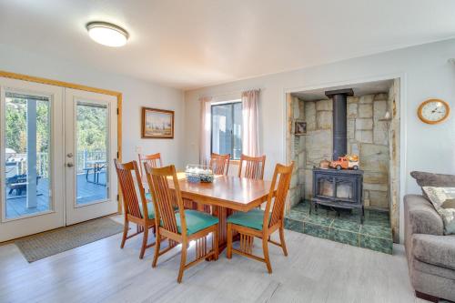 a dining room with a table and chairs and a fireplace at Eagar Vacation Rental Home with Spacious Deck! in Springerville