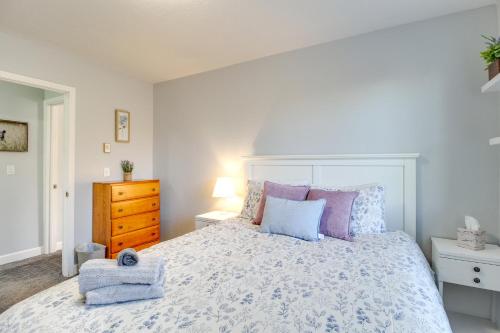 a bedroom with a large bed with purple and blue pillows at Eagar Vacation Rental Home with Spacious Deck! in Springerville