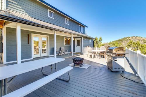 a large deck with a grill and a house at Eagar Vacation Rental Home with Spacious Deck! in Springerville