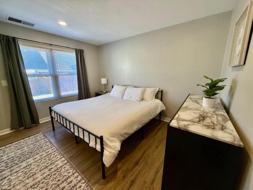 a bedroom with a large bed and a window at Aksarben View Gem-Near UNO in Omaha