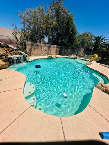 a small pool with a water feature in a backyard at LAS VEGAS SPACIOUS ROOM Close to Everything in Las Vegas