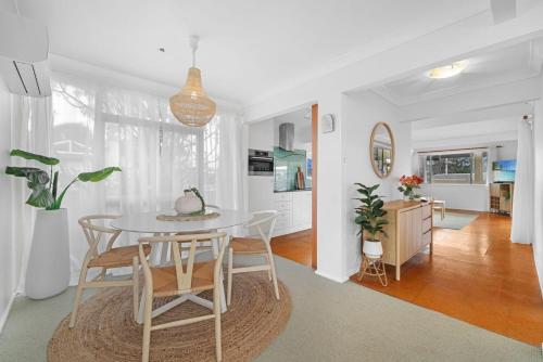a kitchen and dining room with a table and chairs at Vincentia Beach Bungalow Your Coastal Escape in Vincentia