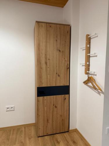 a wooden door in the corner of a room at Školní 60 in Pelhřimov