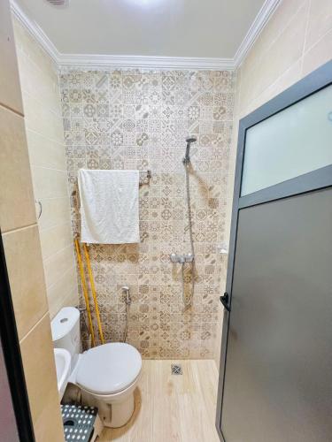a bathroom with a toilet and a shower at ocean view house in Imsouane