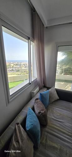 a couch in a room with a large window at Bizerte Résidence soltana RDC vue mer in Bizerte