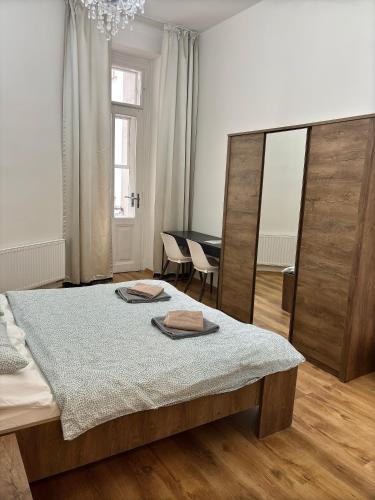 a bedroom with a bed with two towels on it at Apartment Belveder Brno in Brno