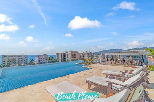 a view of a swimming pool with chaise lounge chairs at Vista Bucerias - Rooftop Pool & Stunning Views in Bucerías