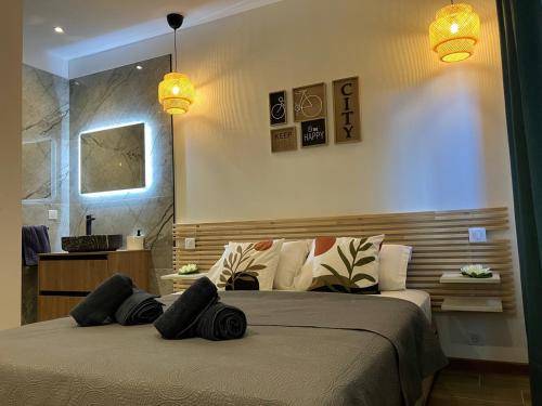 - une chambre avec un lit doté d'oreillers noirs dans l'établissement Villa luxury vue mer au centre-ville de Porto Vecchio, à Porto-Vecchio