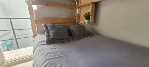 a bed with two pillows in a room with a window at Las Aguas Inner Experience in Bogotá